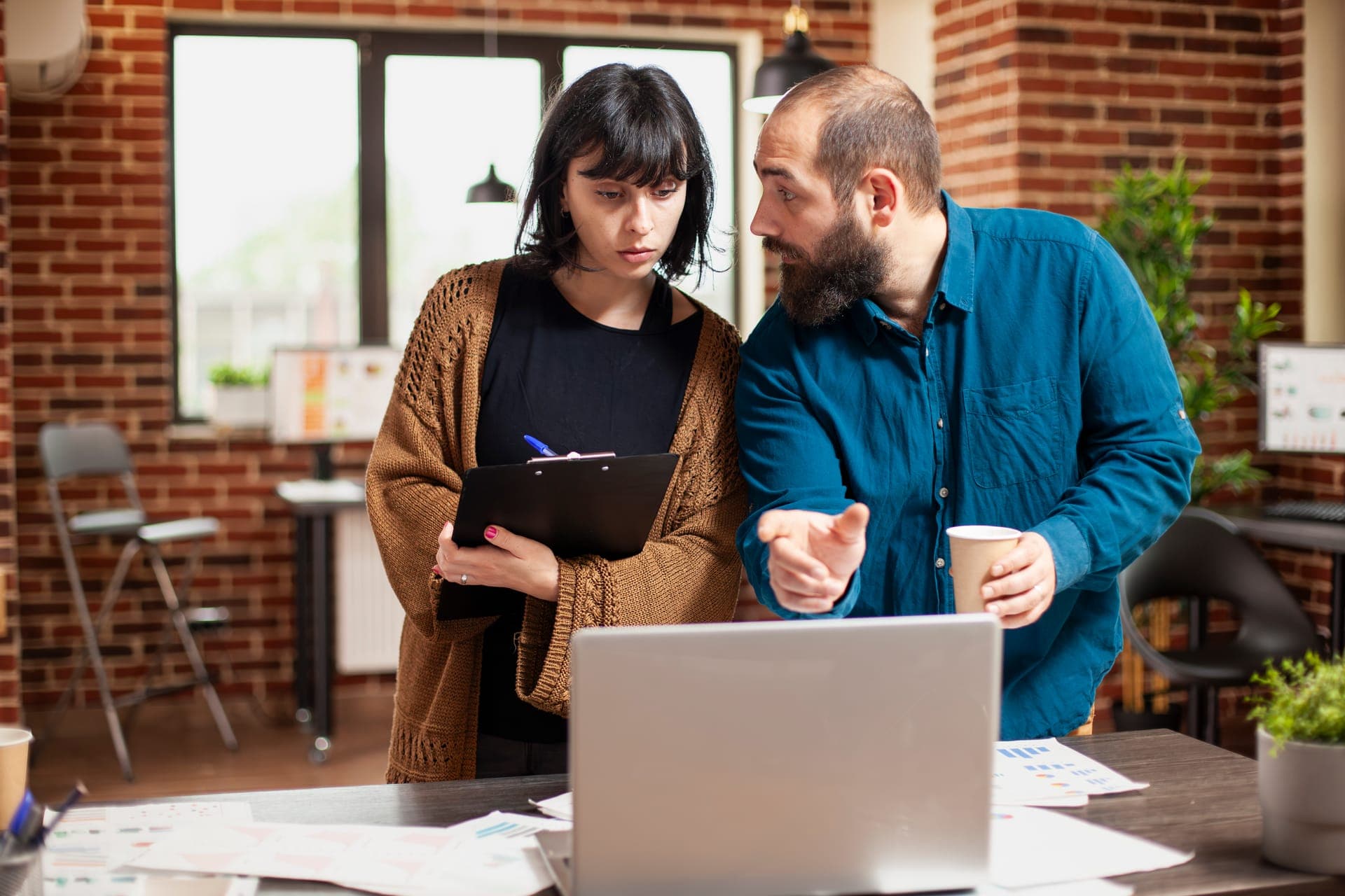 Web designer showing a website design to a business owner during a meeting
