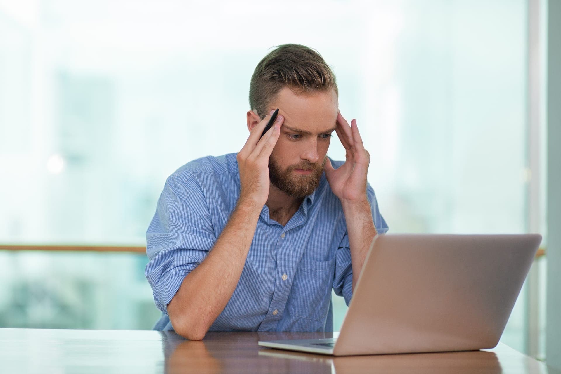 Business owner getting frustrated while building a website themselves